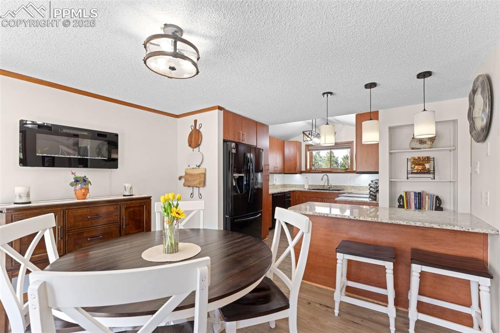 1851 Buttercup Road Elizabeth, CO 80107 - Photo 18 of 47 a dining room with furniture and wooden floor