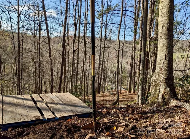 a balcony with wooden floor and trees