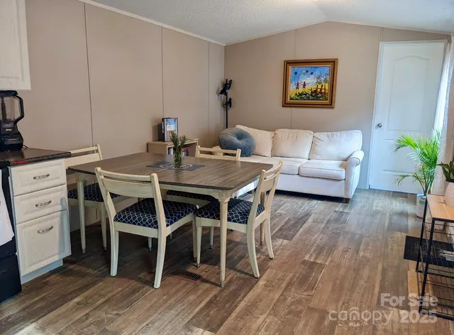 a living room with furniture flowerpot and wooden floor