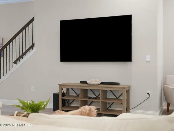 a living room with furniture and a flat screen tv
