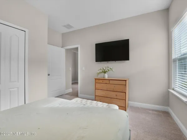 a bedroom with a bed and window