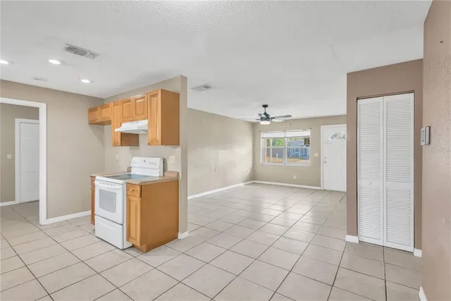 a view of kitchen with cabinets and window