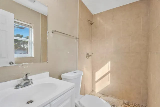 a bathroom with a sink toilet and shower