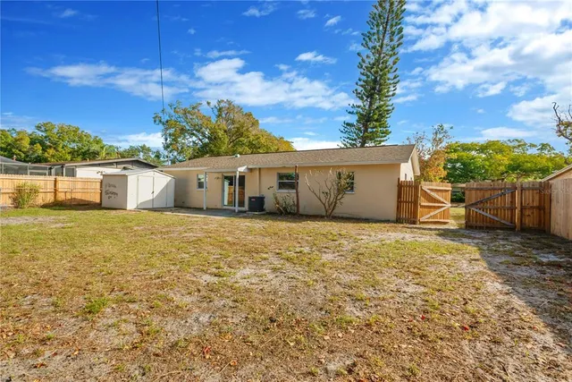 a front view of a house with a garden and yard