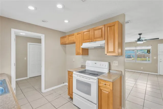 a kitchen that has a sink and a stove in it