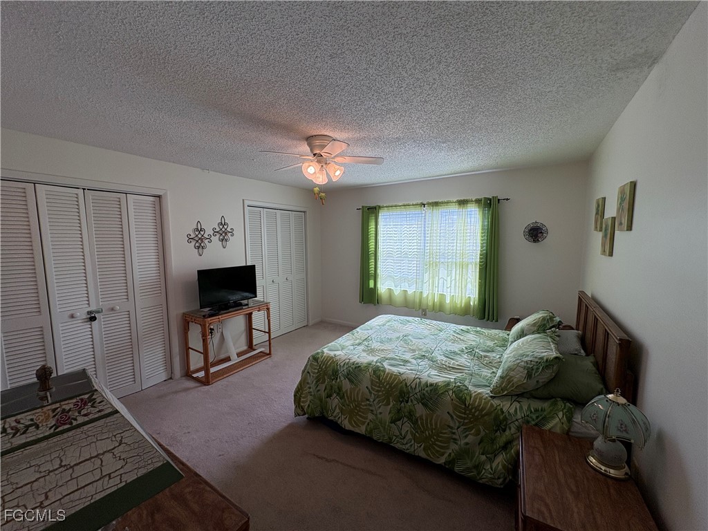 1830 Brantley Road, Unit J1 Fort Myers, FL 33907 - Photo 11 of 39 a bedroom with a bed and a tv