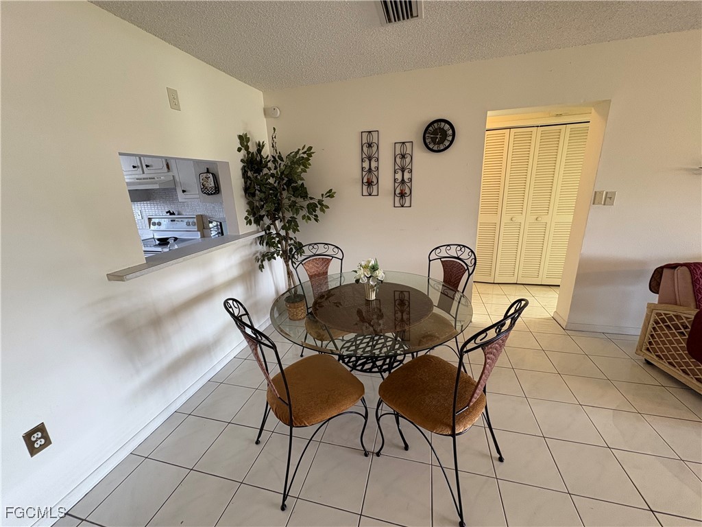1830 Brantley Road, Unit J1 Fort Myers, FL 33907 - Photo 14 of 39 a dining room with furniture and window