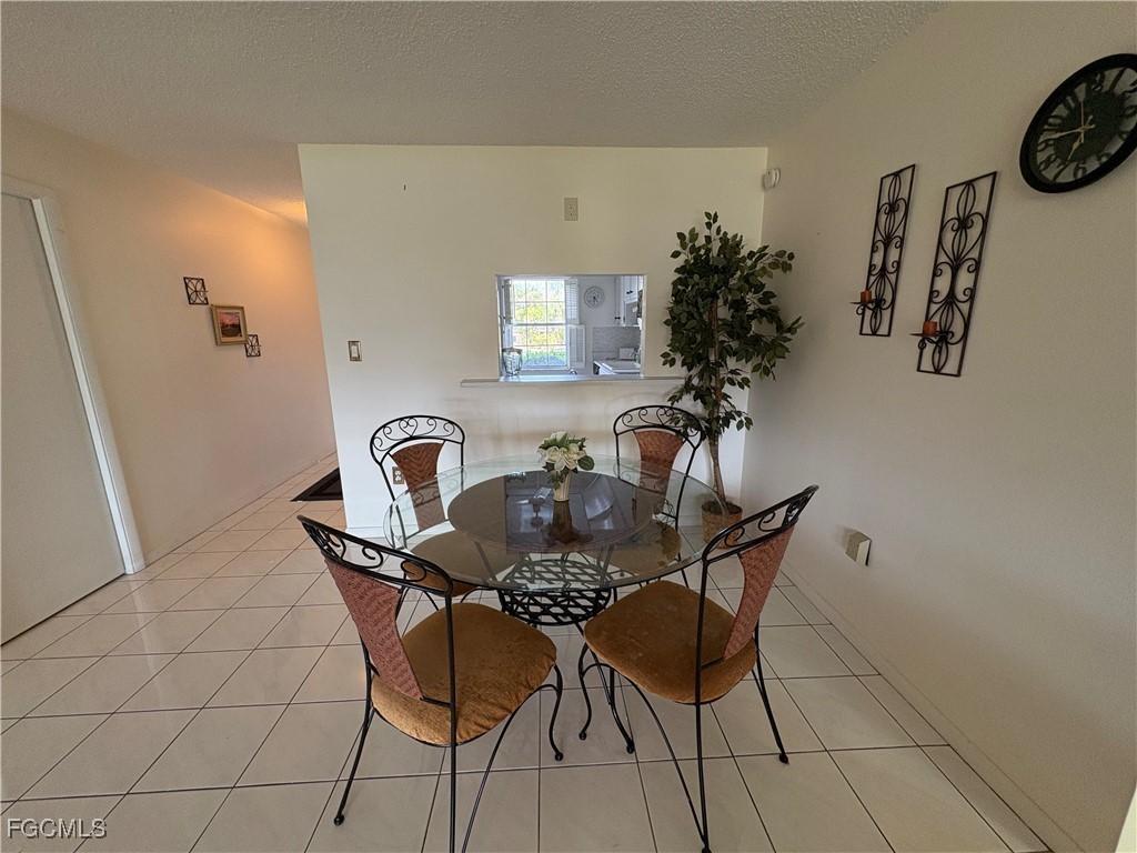 1830 Brantley Road, Unit J1 Fort Myers, FL 33907 - Photo 15 of 39 a dining room with furniture and wooden floor