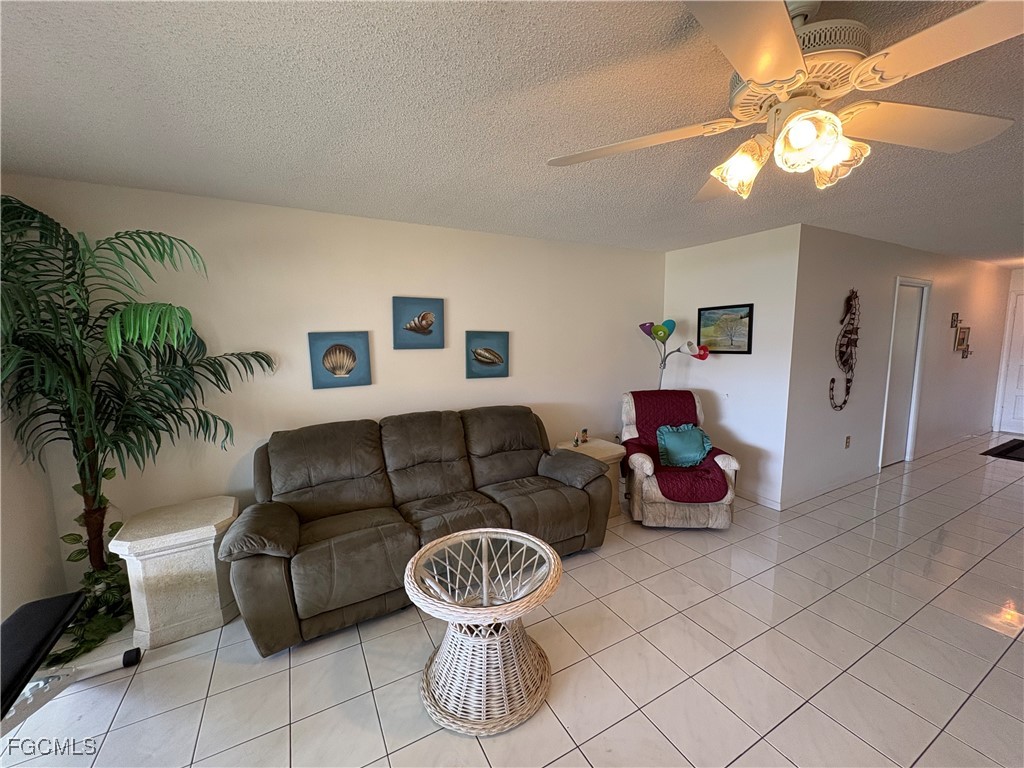 1830 Brantley Road, Unit J1 Fort Myers, FL 33907 - Photo 2 of 39 a living room with furniture and a chandelier