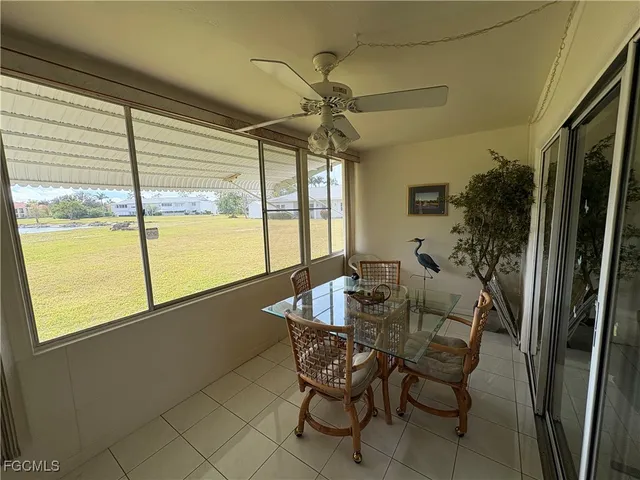 a dining room with furniture and window