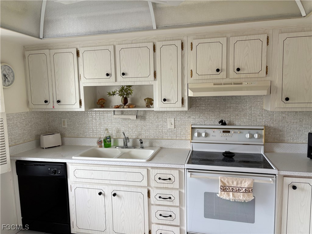 1830 Brantley Road, Unit J1 Fort Myers, FL 33907 - Photo 3 of 39 a kitchen with white cabinets and appliances