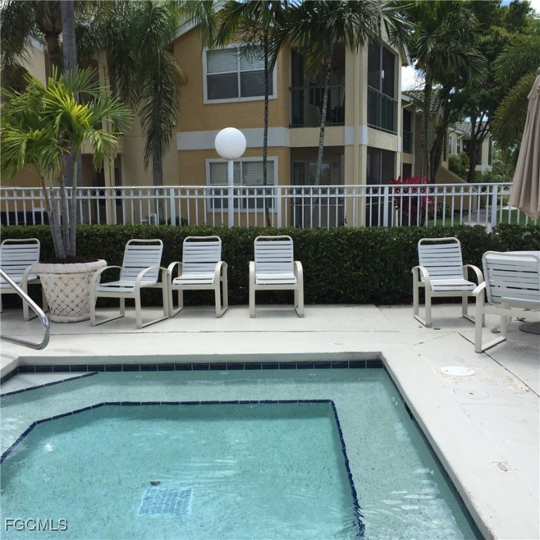 1830 Brantley Road, Unit J1 Fort Myers, FL 33907 - Photo 31 of 39 a view of a patio with couches table and chairs and potted plants