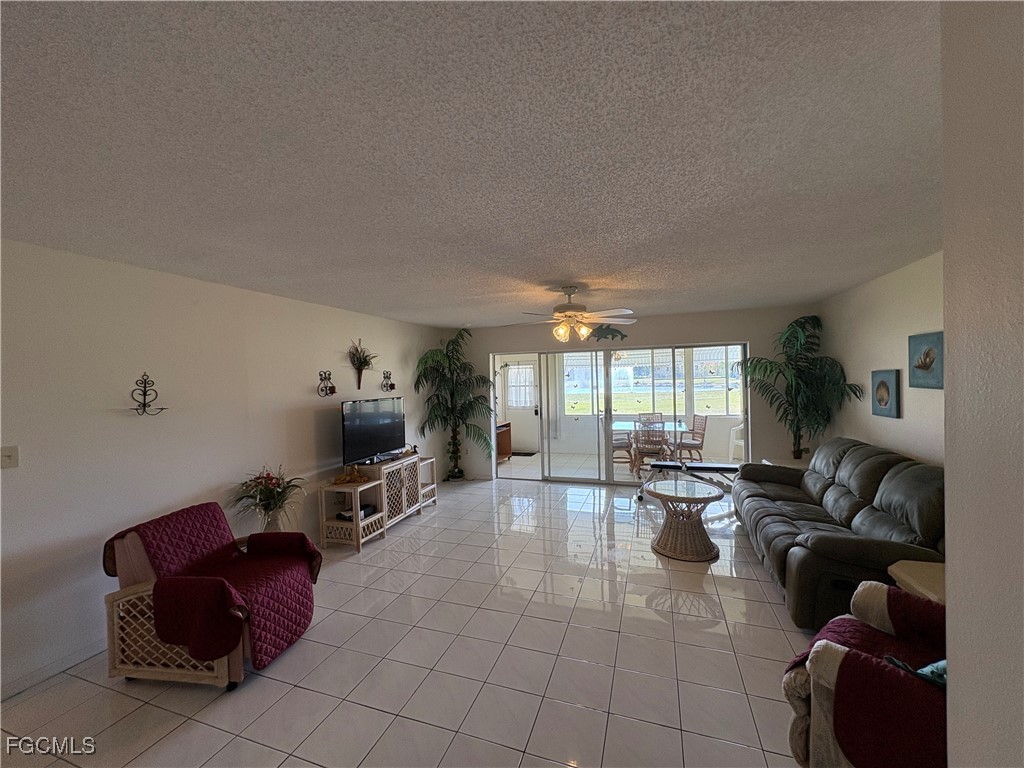 1830 Brantley Road, Unit J1 Fort Myers, FL 33907 - Photo 9 of 39 a living room with furniture large window and flat screen tv