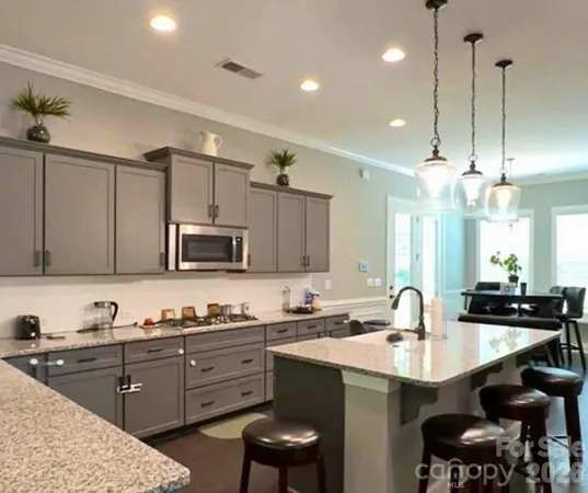 a kitchen with a sink stove and microwave
