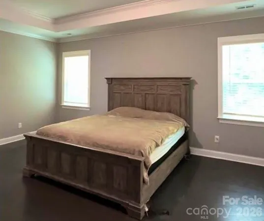 a bed sitting in a bedroom next to a window