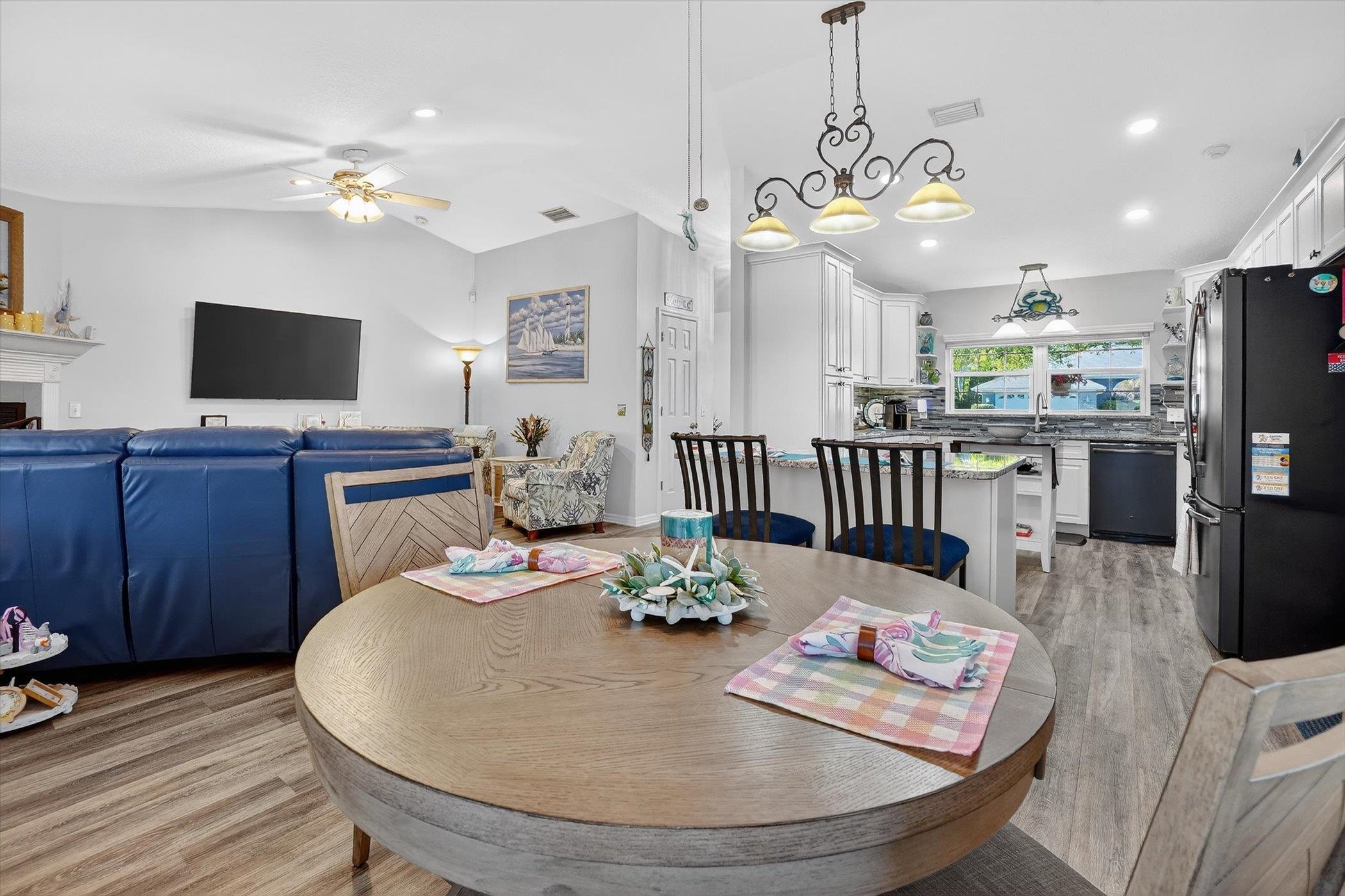 229 Yale Road St. Augustine, FL 32086 - Photo 12 of 47 Dining area with a ceiling fan, lofted ceiling, light wood-style floors, a fireplace, and recessed lighting