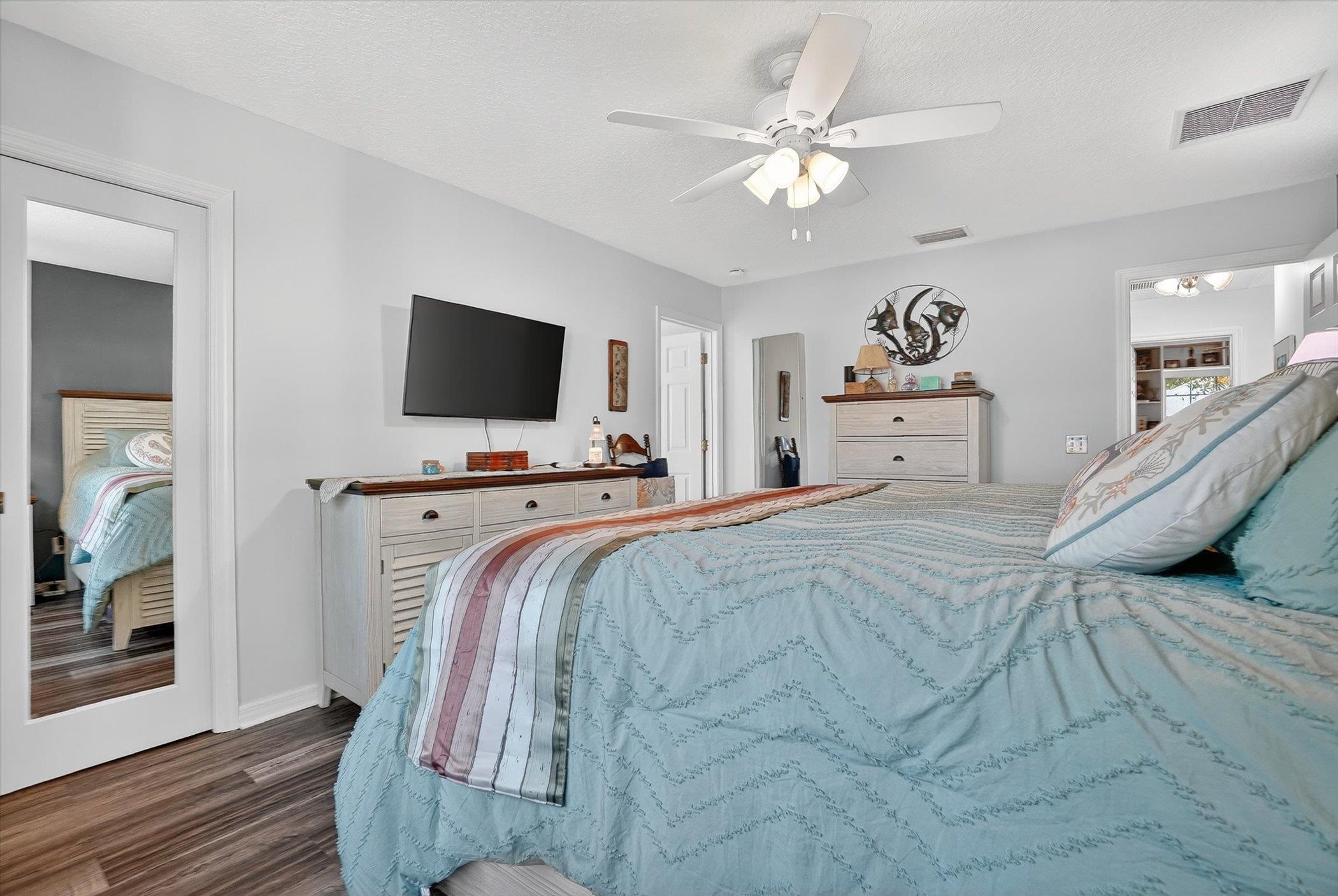 229 Yale Road St. Augustine, FL 32086 - Photo 17 of 47 Bedroom featuring ceiling fan, dark wood-type flooring, and a textured ceiling