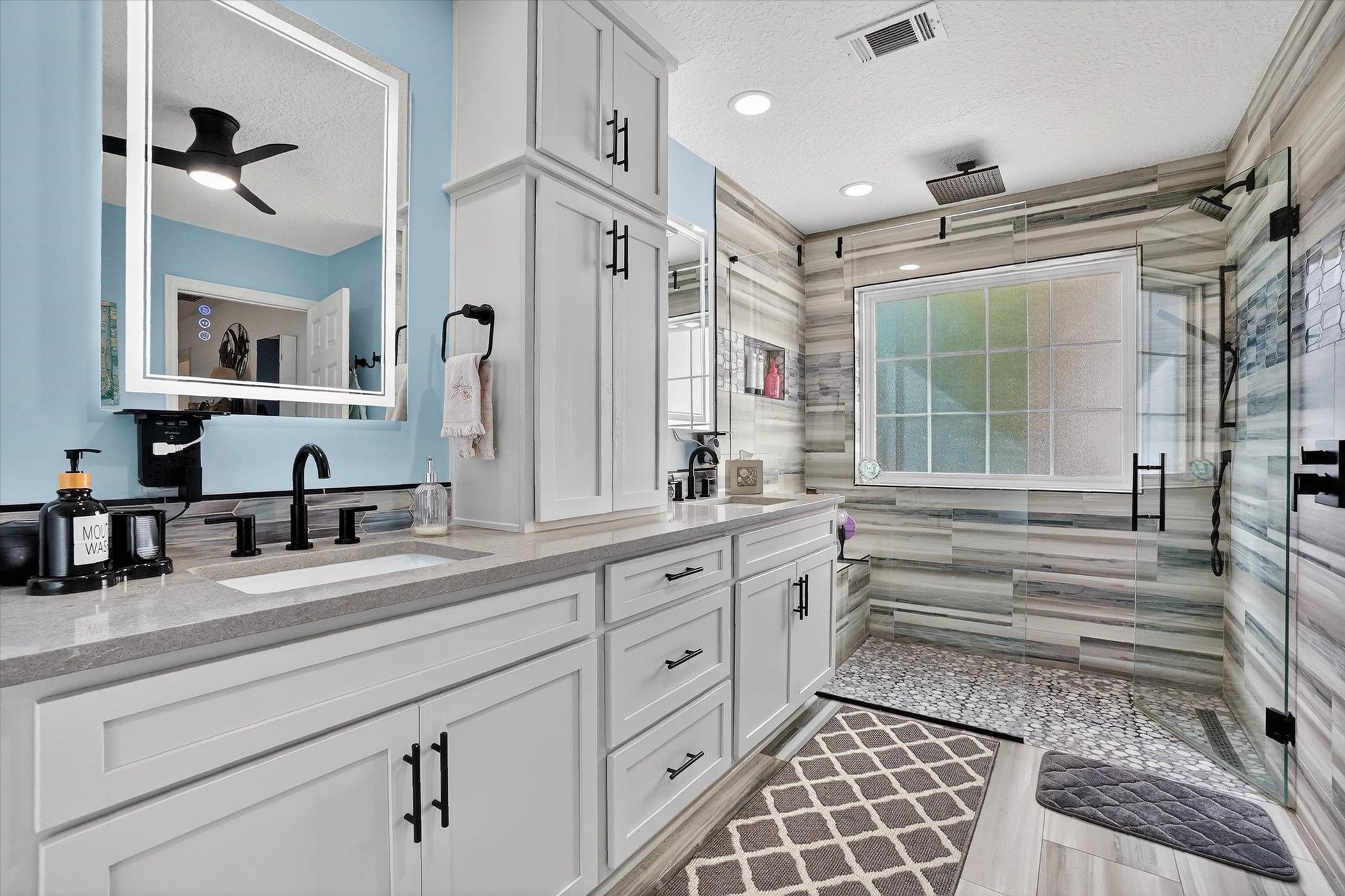 229 Yale Road St. Augustine, FL 32086 - Photo 21 of 47 Full bath featuring double vanity, a textured ceiling, a shower stall, and a ceiling fan