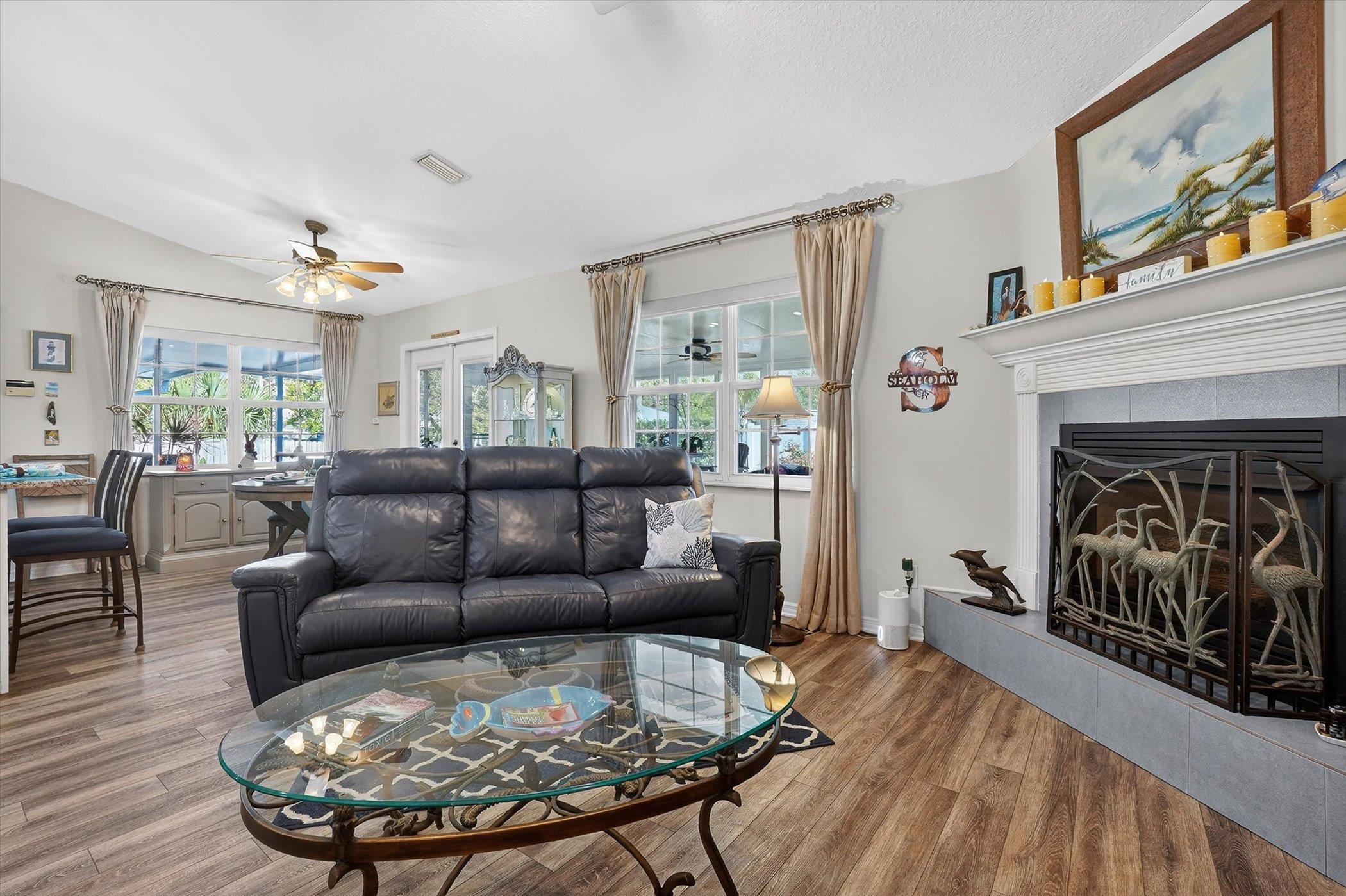 229 Yale Road St. Augustine, FL 32086 - Photo 31 of 47 Living room with a ceiling fan, wood finished floors, a tile fireplace, and lofted ceiling