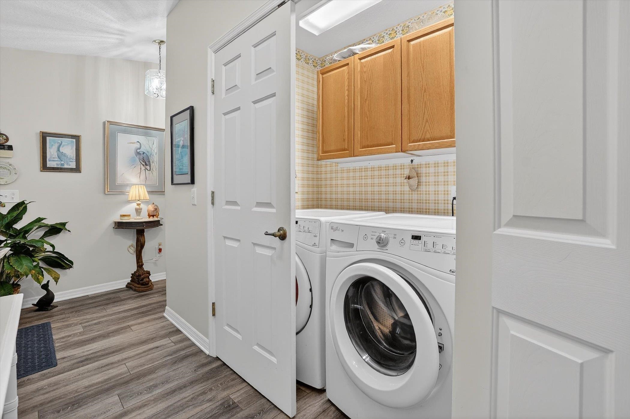 229 Yale Road St. Augustine, FL 32086 - Photo 38 of 47 Laundry area with cabinet space, independent washer and dryer, and light wood-type flooring