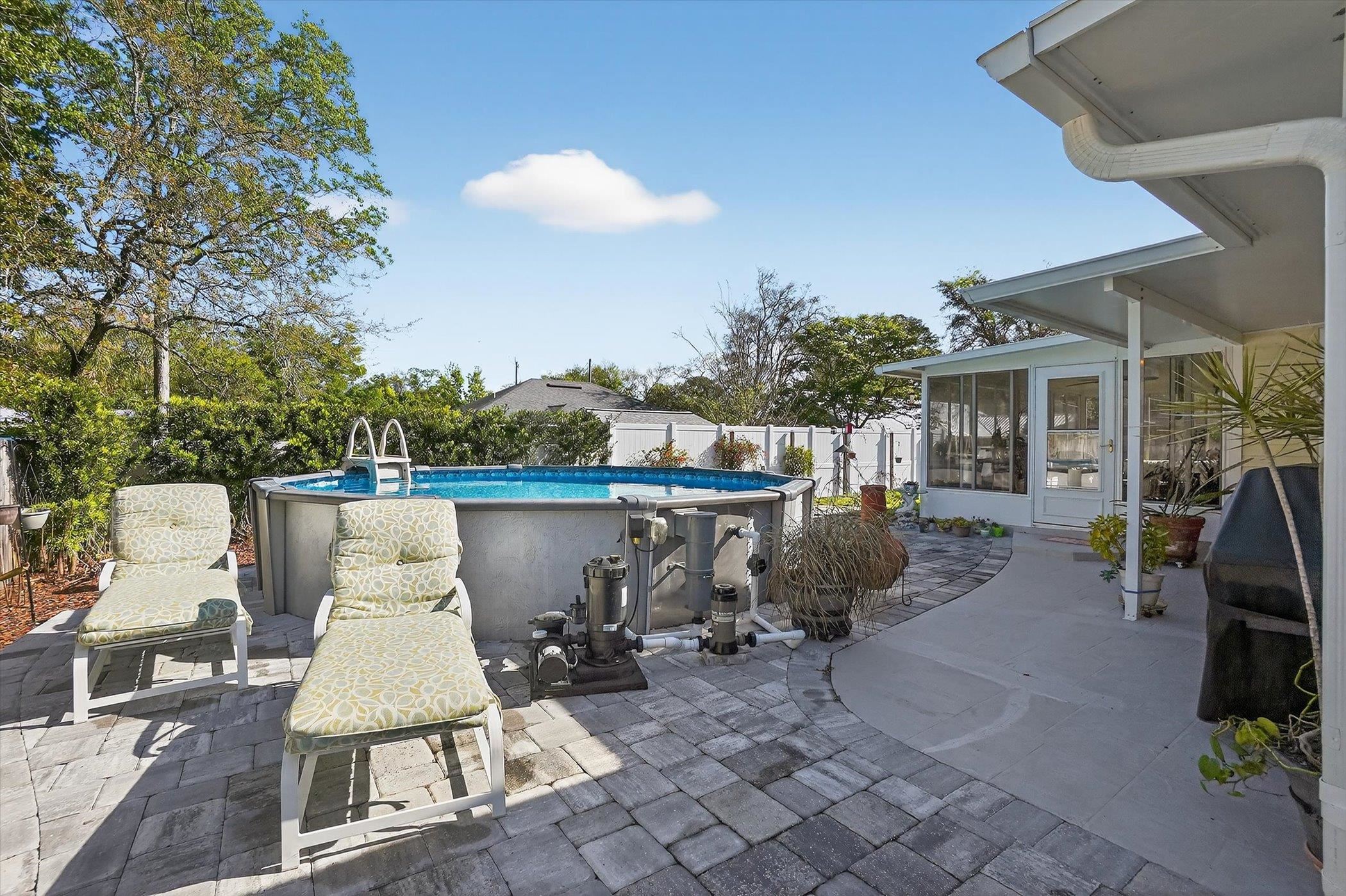 229 Yale Road St. Augustine, FL 32086 - Photo 39 of 47 Fenced backyard featuring a patio area, an outdoor pool, a sunroom, and area for grilling