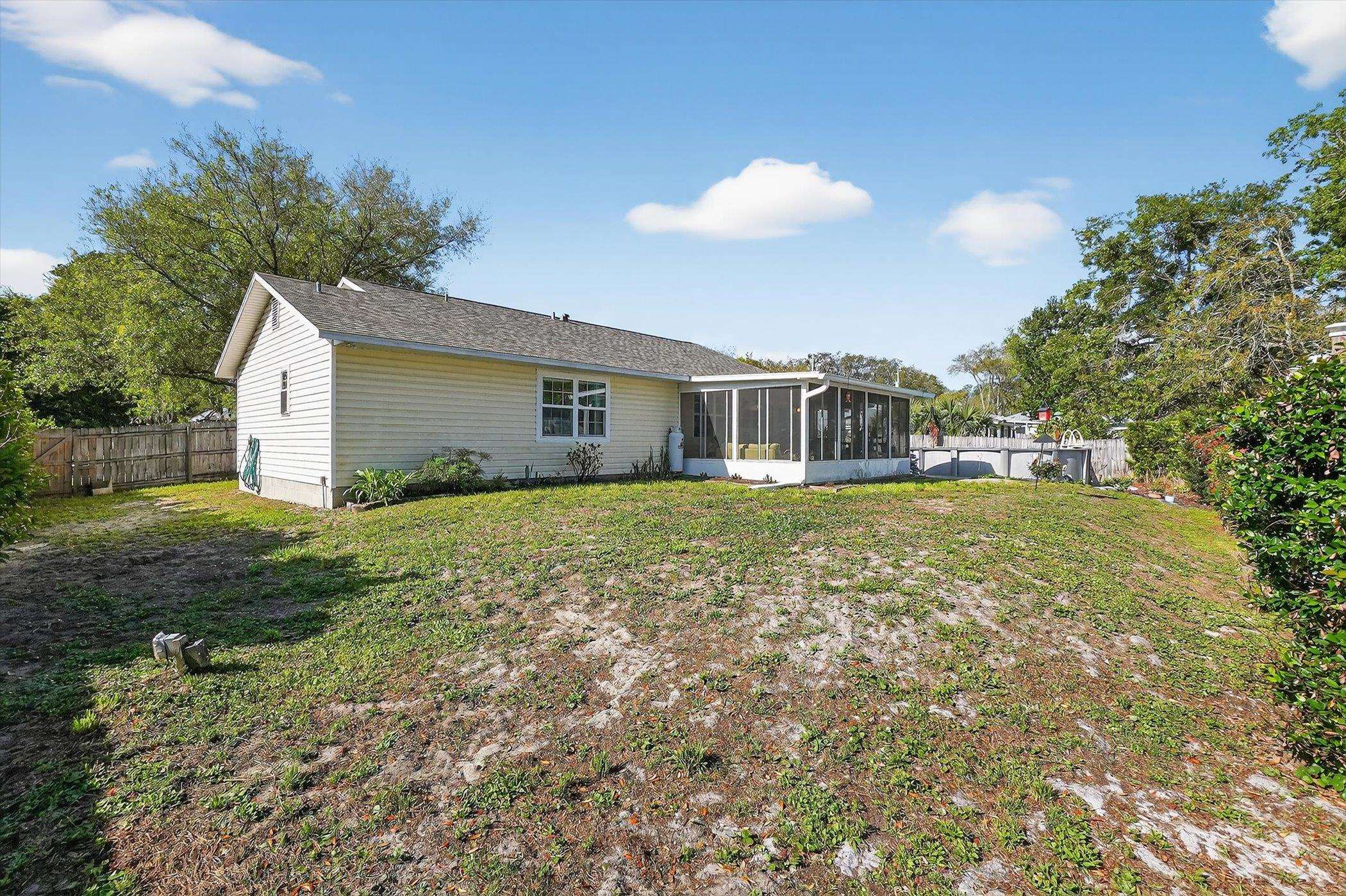229 Yale Road St. Augustine, FL 32086 - Photo 46 of 47 Rear view of property featuring a sunroom and a fenced backyard