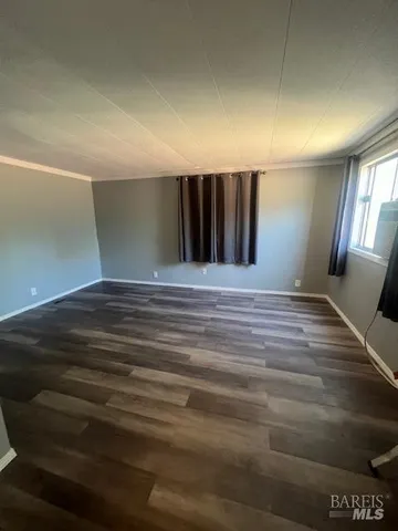 a view of a hallway with wooden floor and stairs