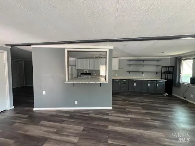 a view of a room with wooden floor