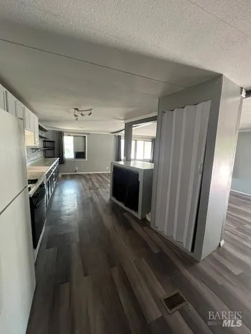 a view of a living room a window and wooden floor