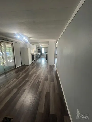 a view of a hallway with wooden floor