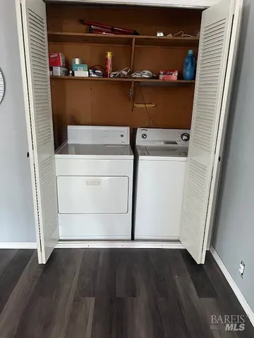 a view of empty room with window and hardwood floor