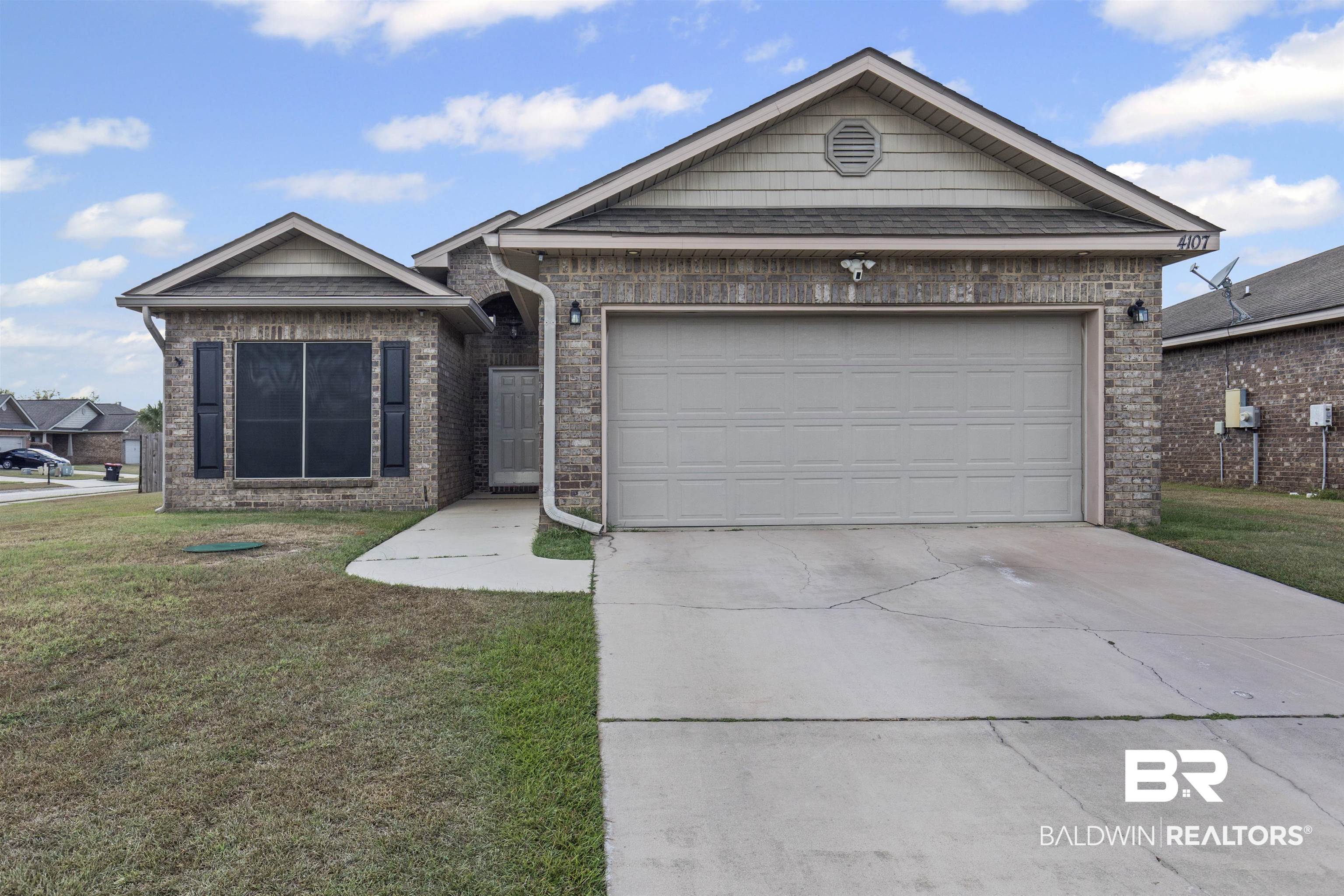 4107 Nottingham Drive Semmes, AL 36575 - Photo 2 of 23 Single story home featuring a front yard, brick siding, driveway, and a garage