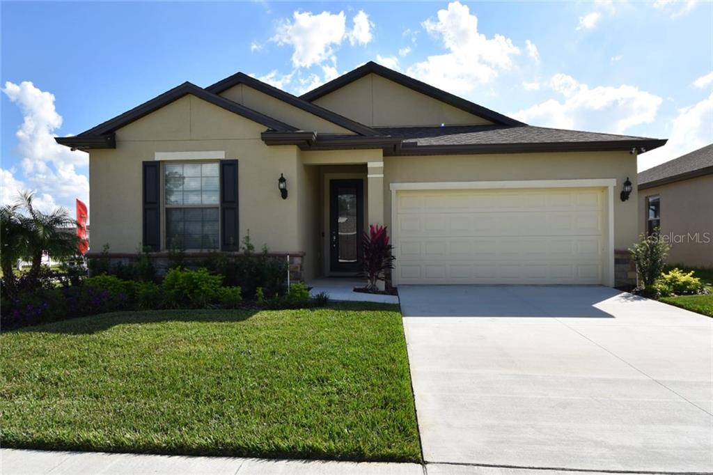 8767 Rindge Road Polk City, FL 33868 - Photo 1 of 1 a front view of a house with a garden and plants