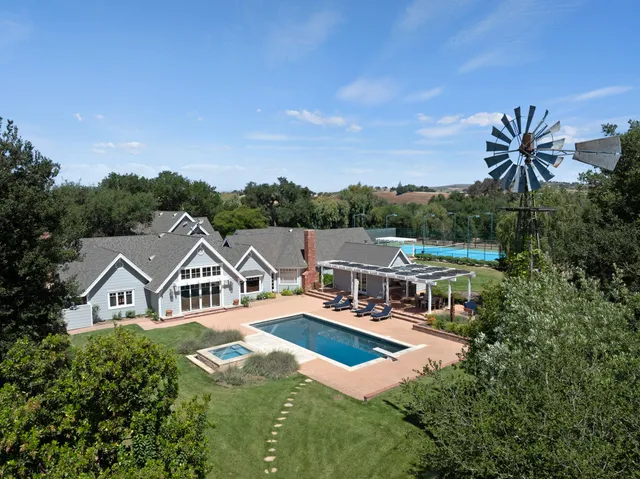 a view of a house with pool and porch