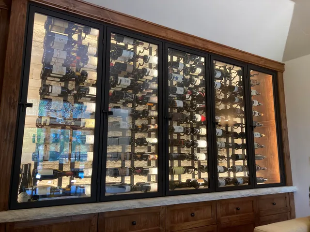 a kitchen with stainless steel appliances granite countertop a stove and white cabinets with wooden floor