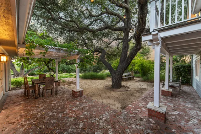 a living room with furniture a large window and a fireplace
