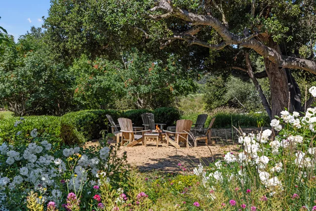 a dining room with furniture a chandelier and wooden floor