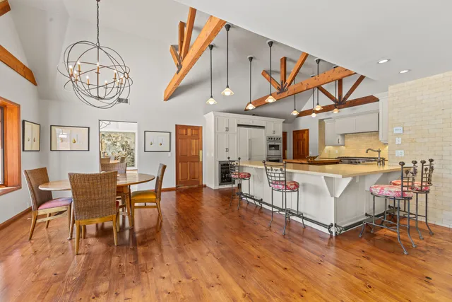a view of a dining room with furniture wooden floor and chandelier