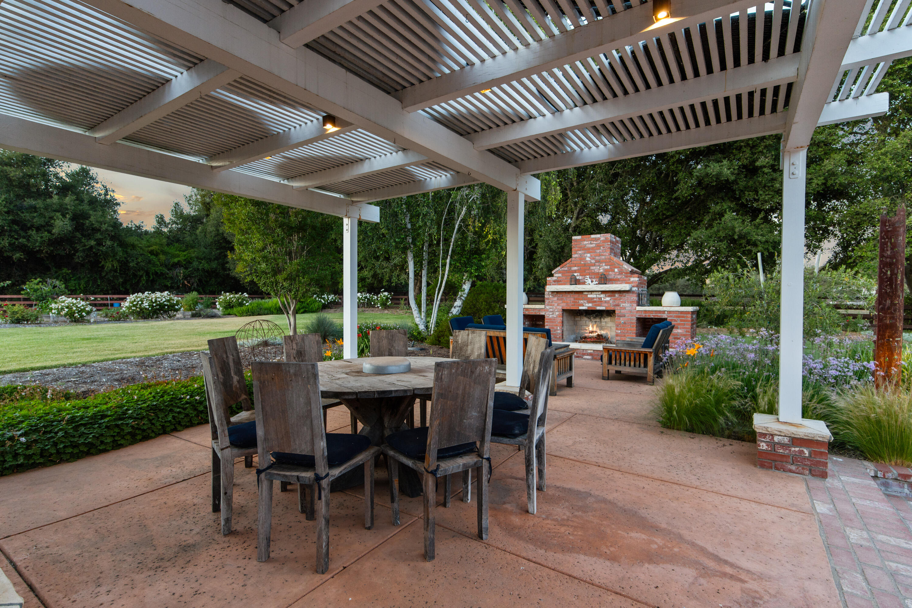 1642 Alamo Pintado Road Solvang, CA 93463 - Photo 20 of 85 a view of a patio with a table chairs and a backyard