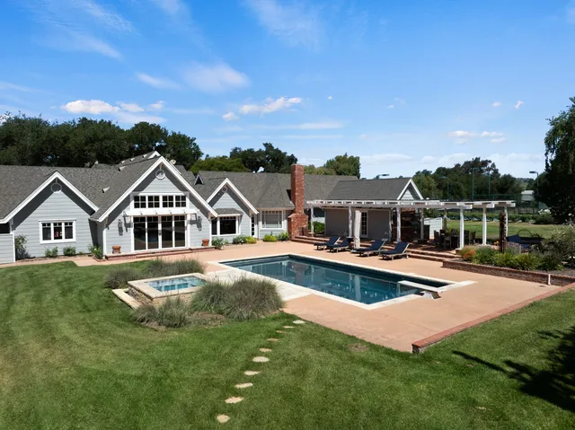 a wooden bench sitting in front of a house