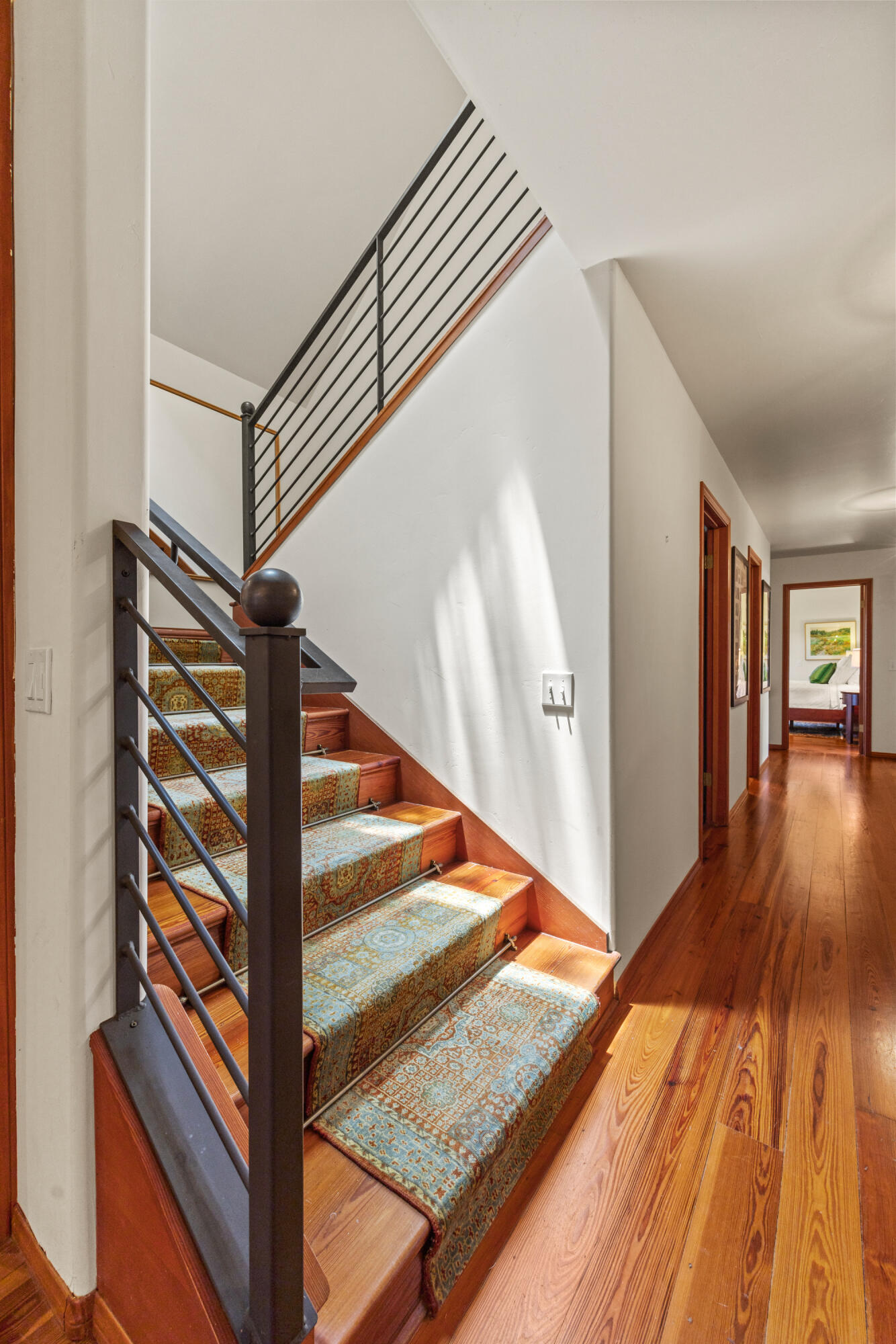 1642 Alamo Pintado Road Solvang, CA 93463 - Photo 28 of 85 a view of a hallway with wooden floor and staircase