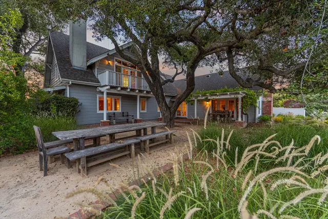 a living room with furniture a flat screen tv and a floor to ceiling window