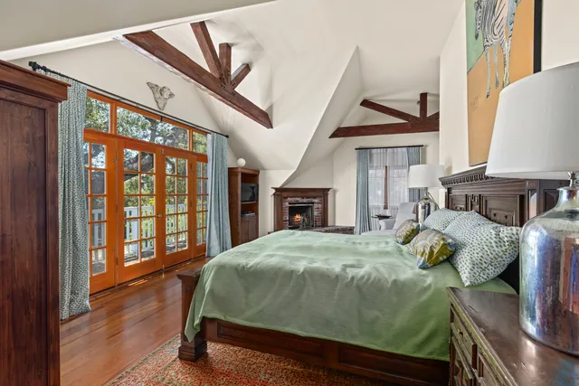 a bedroom with a bed and a dresser next to a window