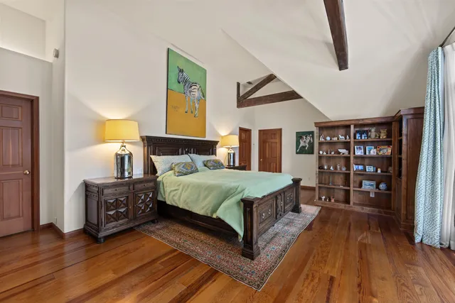 a bedroom with a large bed and a window