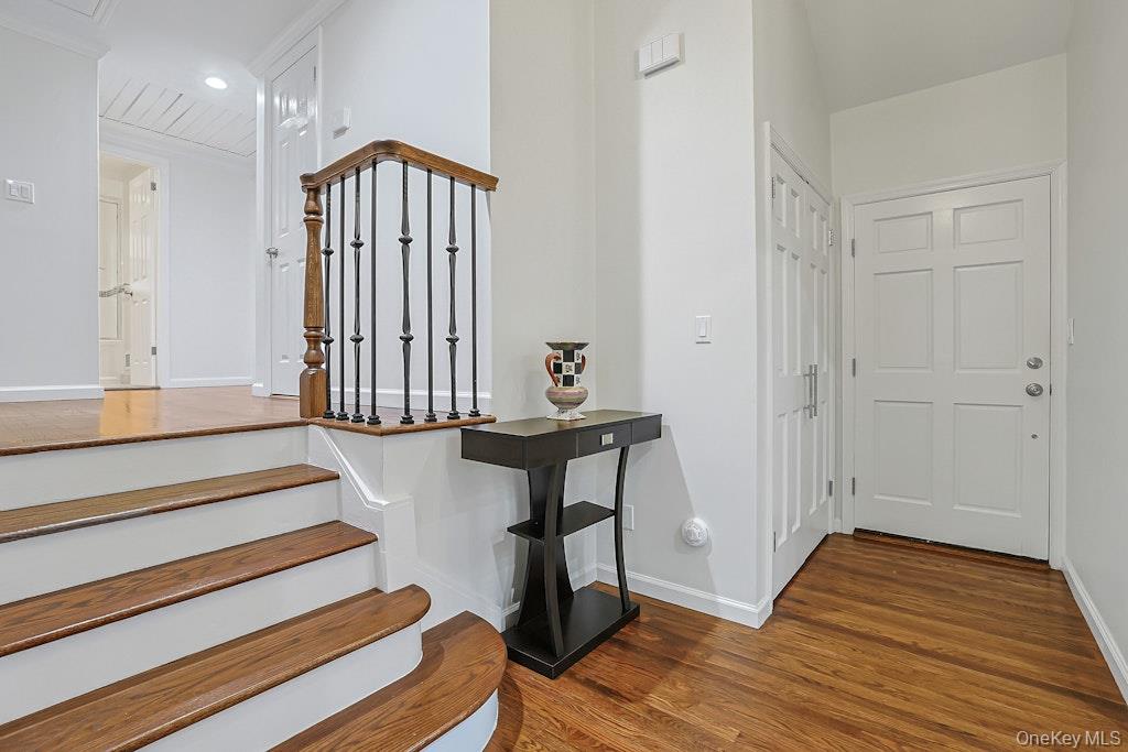 305 Stratton Road New Rochelle, NY 10804 - Photo 2 of 32 a view of a hallway with wooden floor and a cabinet