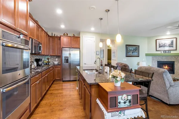 a large kitchen with a large counter top appliances and cabinets