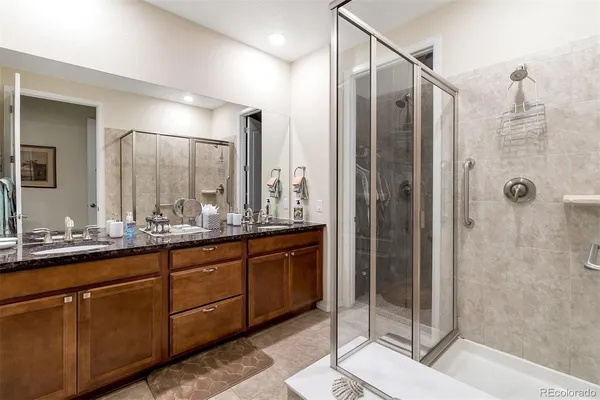 a bathroom with a double vanity sink and mirror