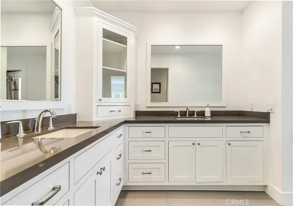 a bathroom with double sink and a mirror