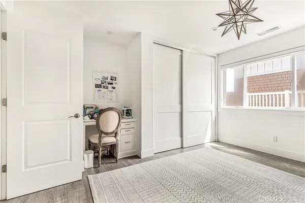 a view of a room with wooden floor and windows