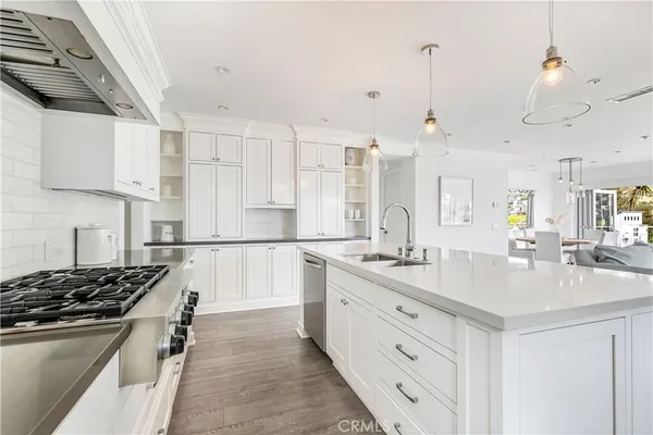 a kitchen with white cabinets and appliances